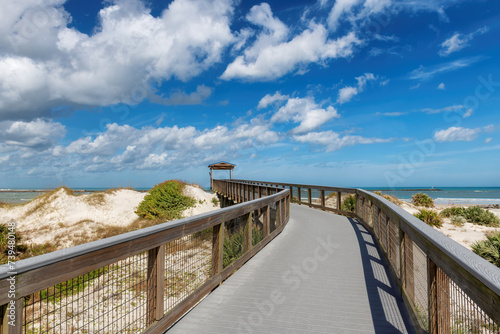 Smyrna Dunes Park with elevated boardwalk and fishing pier in New Smyrna Beach, Florida. photo