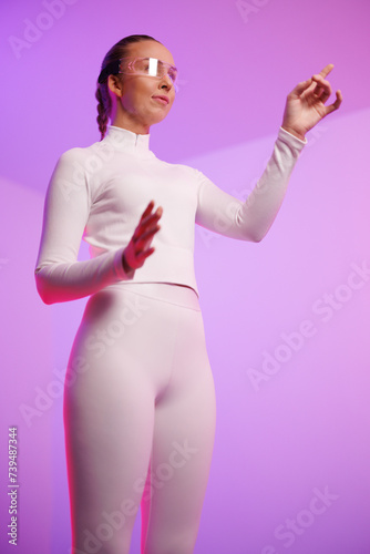 Woman in smartglasses pointing against purple background