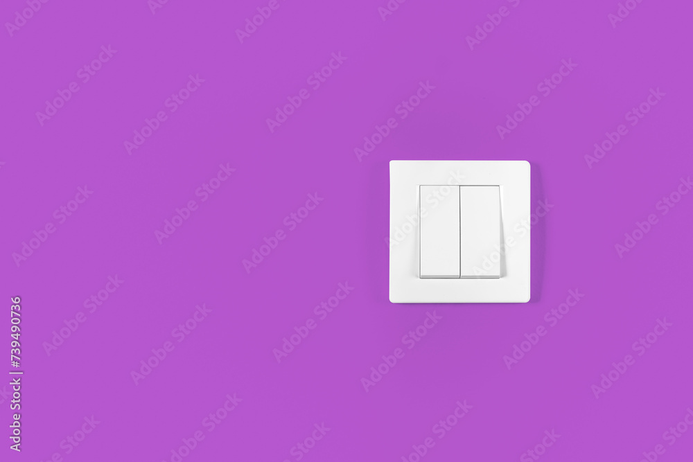 White light switch against purple wall background. White light switch against purple wall background.