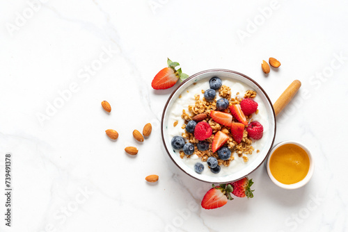Healthy breakfast bowl with ingredients granola fruits Greek yogurt and berries top view. Weight loss, healthy lifestyle and eating concept