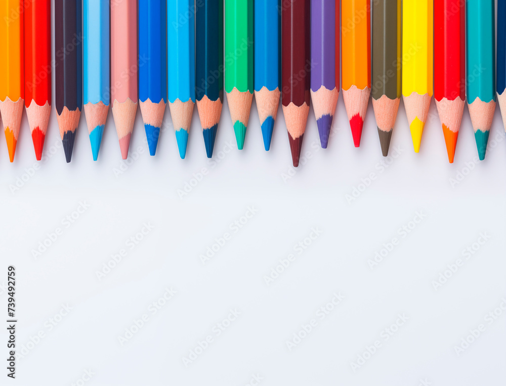 Colored pencils on a white background, top view with copy space. Back to school. Stationery, pencils for drawing Colored pencils on a white background, top view with copy space. Back to school. Stationery, pencils for drawing