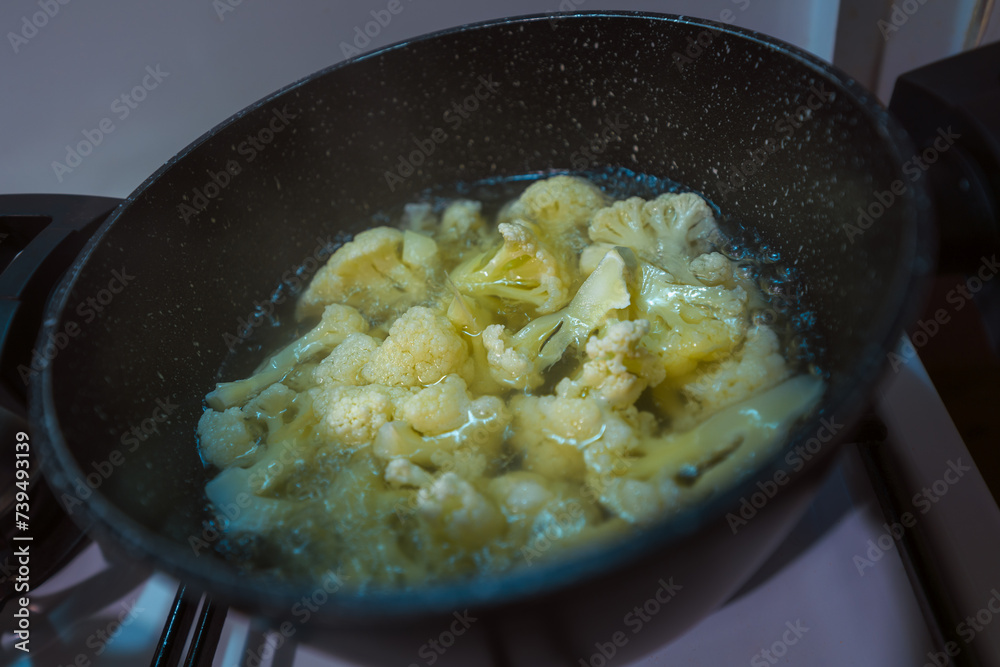 Boiling cauliflower in a pot. Cooking healthy food Boiling cauliflower in a pot. Cooking healthy food