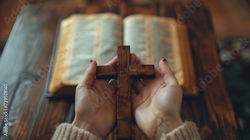 A woman who believes in a higher power is pictured holding a wooden cross on ...