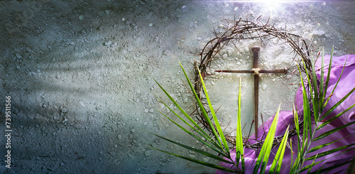 Lent - Crown Of Thorns and Cross With Purple Robe On Ash - Palm Leaves And Bloody Spikes For Penitence Concept With Abstract Sunlight photo
