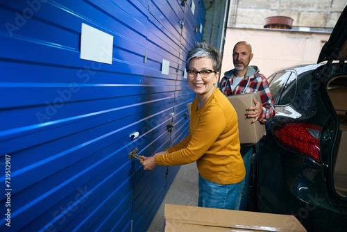 Smiling lady opening storage door for things