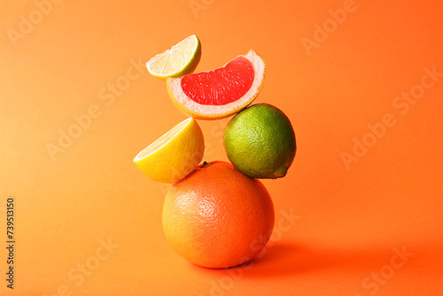 Fototapeta Naklejka Na Ścianę i Meble -  Fresh ripe citrus fruits on orange background