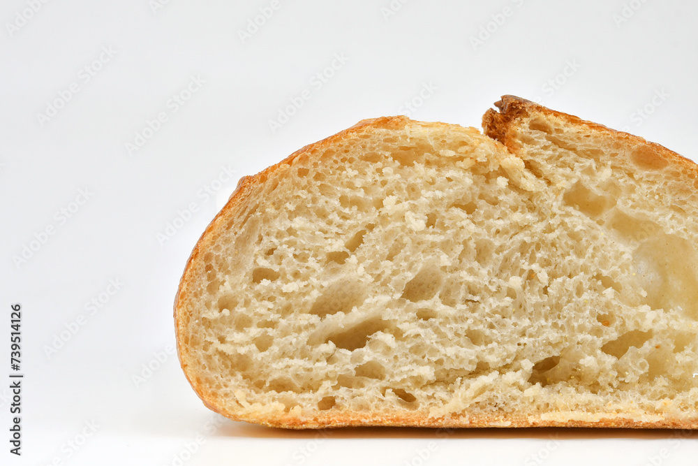 Slice of fresh sourdough bread on a plain white background. Copy space. Slice of fresh sourdough bread on a plain white background. Copy space.