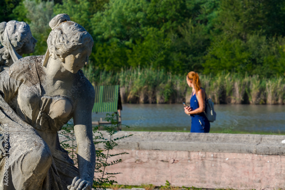 Fototapeta premium Young woman and the Karolyi Castle in Nagymagocs
