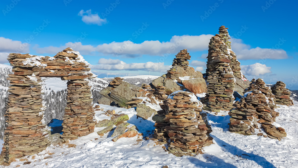 Snow covered massive unique stones display on mountain peak Steinmandl ...