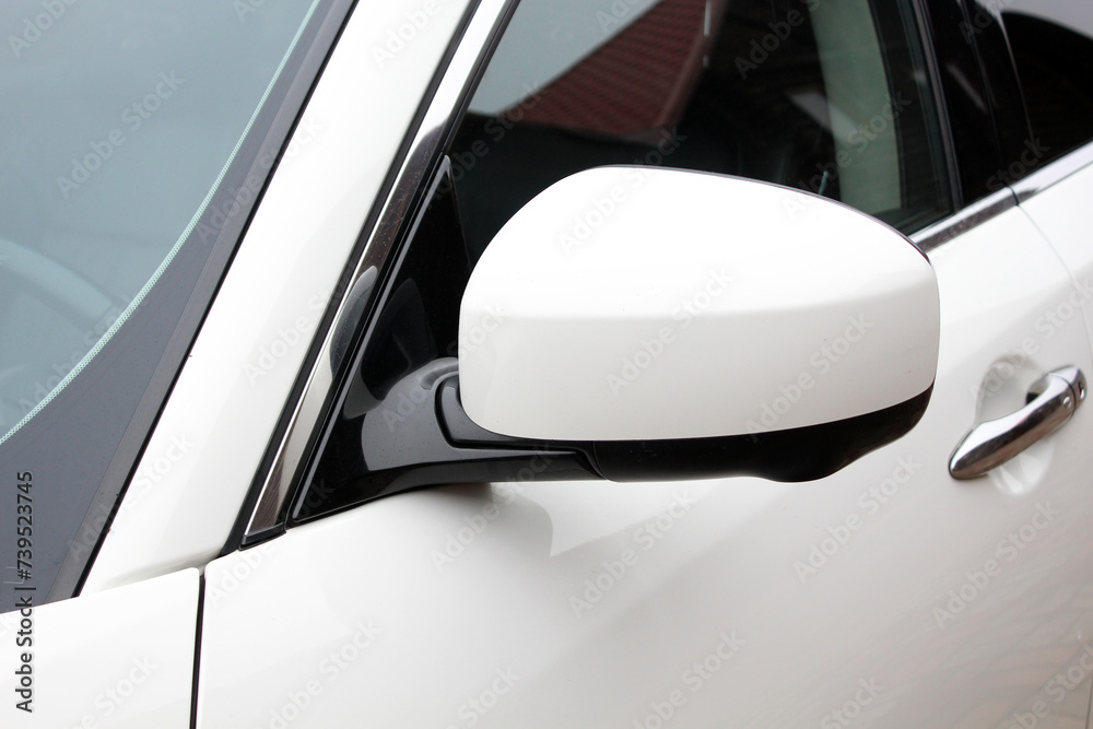 Close-up of the white side mirror of the car. Car mirror with blind spot warning. Car Mirror Cover Rearview Mirror. Close-up of the white side mirror of the car. Car mirror with blind spot warning. Car Mirror Cover Rearview Mirror.