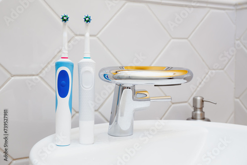 Modern Electric Toothbrushes by Bathroom Sink