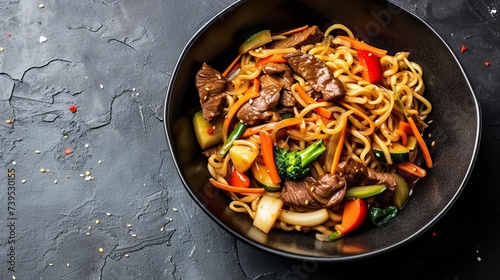 Stir fry noodles with vegetables and beef in black bowl. Slate background Close up. Top view. --ar 16:9 --v 6 Job ID: 837d806d-ab41-473e-9ac4-ce7606ea7760
