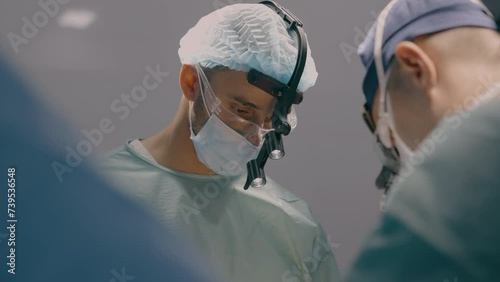 Team of professional surgeons perform heart transplant operation in medical operating room team doctors paramedics in hospital clinic surgical laparoscopy procedure cancer disease surgery health care photo