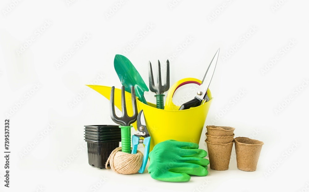Banner on a light table background - garden tools: shovel, rake, green watering can, gloves, pruning shears, garden shears and peat pot. Seasonal gardening concept. Space for copying text. Banner on a light table background - garden tools: shovel, rake, green watering can, gloves, pruning shears, garden shears and peat pot. Seasonal gardening concept. Space for copying text.