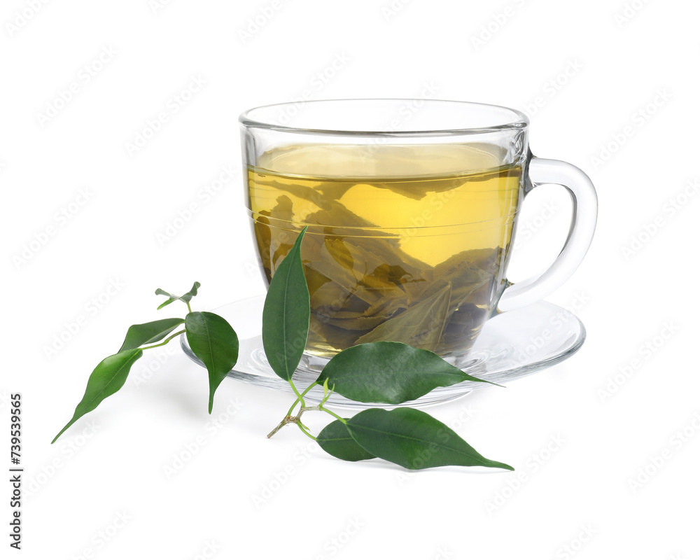 Fresh green tea in glass cup, leaves and saucer isolated on white Fresh green tea in glass cup, leaves and saucer isolated on white