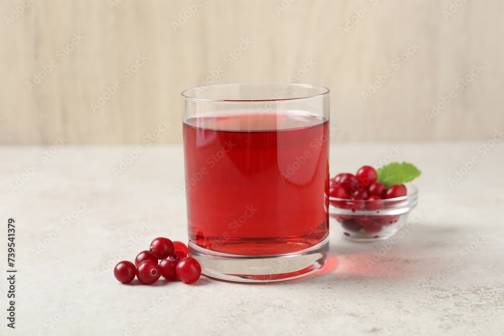 Tasty refreshing cranberry juice and fresh berries on light table Tasty refreshing cranberry juice and fresh berries on light table