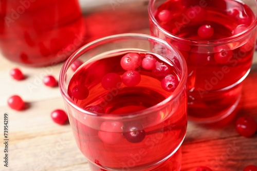 Wallpaper Mural Tasty cranberry juice in glasses and fresh berries on wooden table, closeup Torontodigital.ca