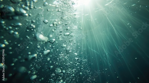 Sunlight underwater with bubbles rising to water surface in the sea © buraratn