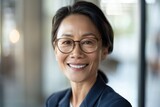 Smiling 45 years old asian american female banker, happy middle aged business man bank manager, mid adult professional businessman ceo executive in office, older mature entrepreneur wearing glasses, h