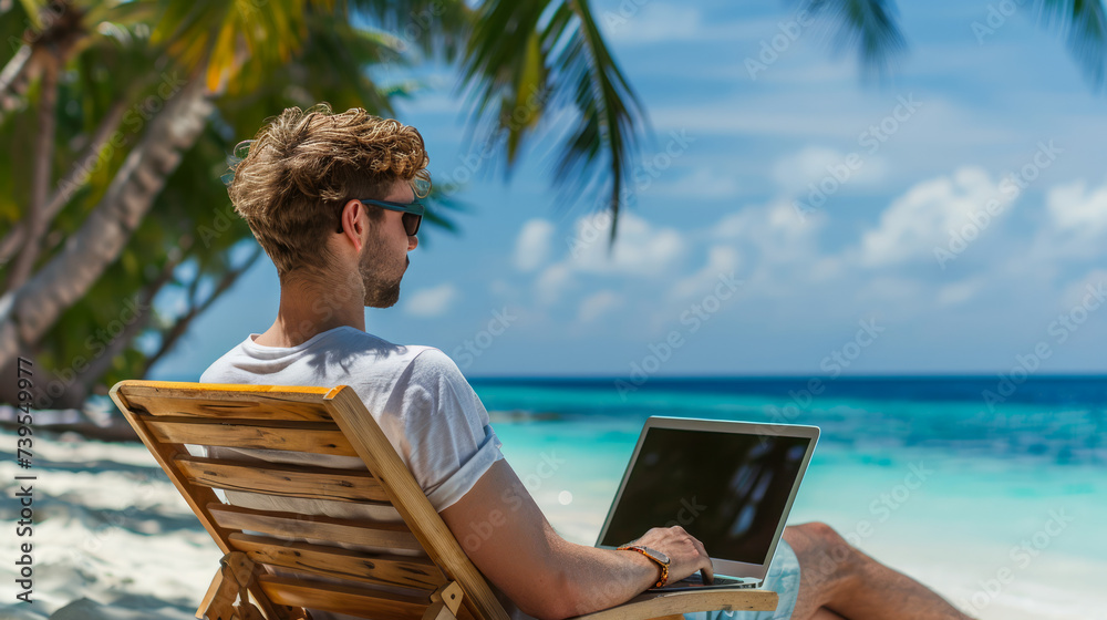 A man sitting on a wooden chair at the beach, working on a laptop with the ocean in the background.  Ai generative