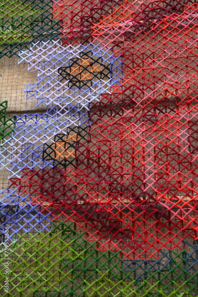Handmade cross-stitch.Embroidered red rose . Handmade cross-stitch.Embroidered red rose .