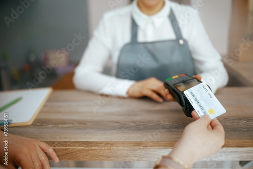 Woman hair salon worker accepting credit card payments photo