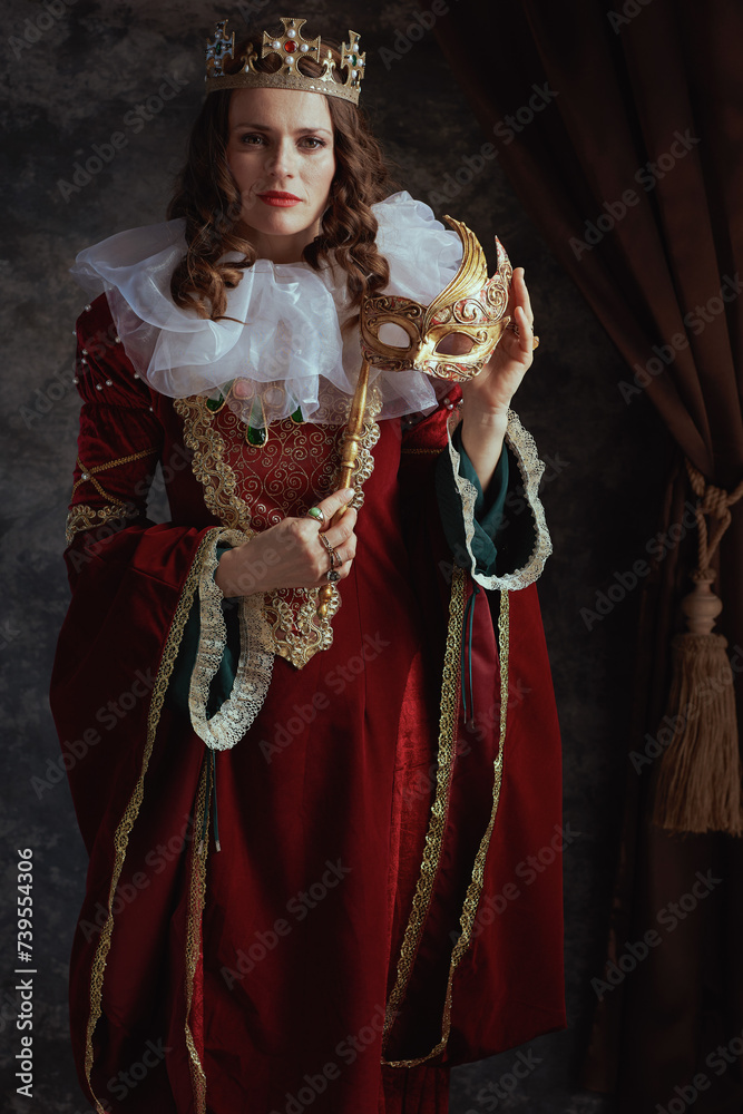 medieval queen in red dress with venetian mask