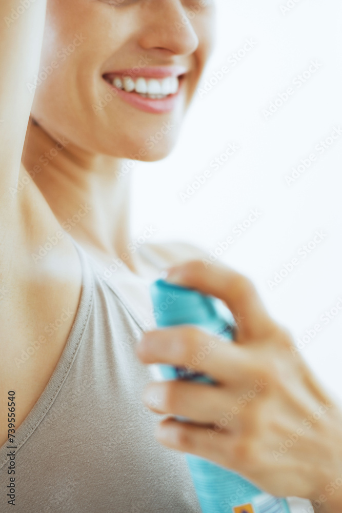 Closeup on young woman applying deodorant on underarm Closeup on young woman applying deodorant on underarm
