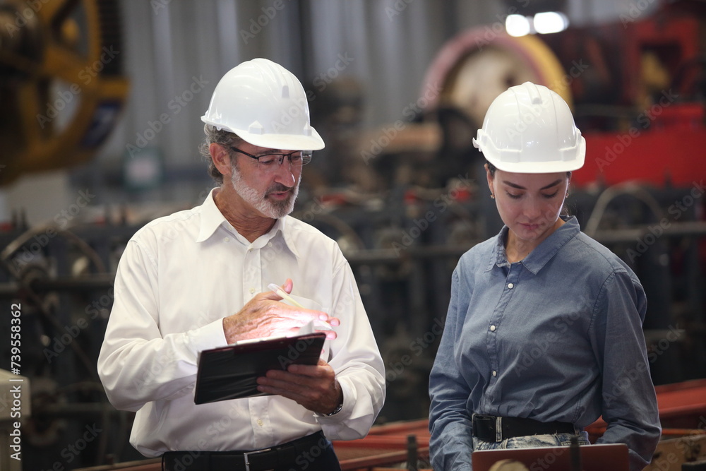 worker or engineer working in factory with safety uniform , safety hat and safety glasses , image is safety concept or happy workplace worker or engineer working in factory with safety uniform , safety hat and safety glasses , image is safety concept or happy workplace