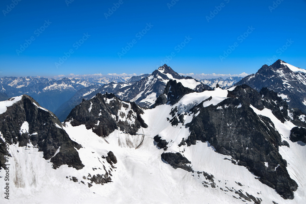 View from top of Mount Titlis, Switzerland. Panoramic view on Snow Alps and Blue Sky around Titlis mountain. Urner Alps. Obwalden