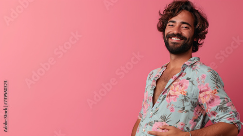 Pregnant trans man on pink background. Non binary individual. 