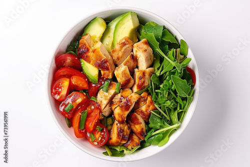 A white bowl filled with chicken, avocado, tomatoes, and spinach