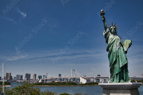 The Statue of Liberty and the Rainbow Bridge in Tokyo Bay. Tokyo Japan 