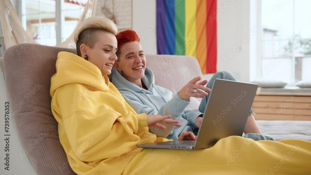A couple shares a cozy moment, watching a film on a laptop at home, intimate and connected as they immerse themselves in the storyline. High quality 4k footage A couple shares a cozy moment, watching a film on a laptop at home, intimate and connected as they immerse themselves in the storyline. High quality 4k footage