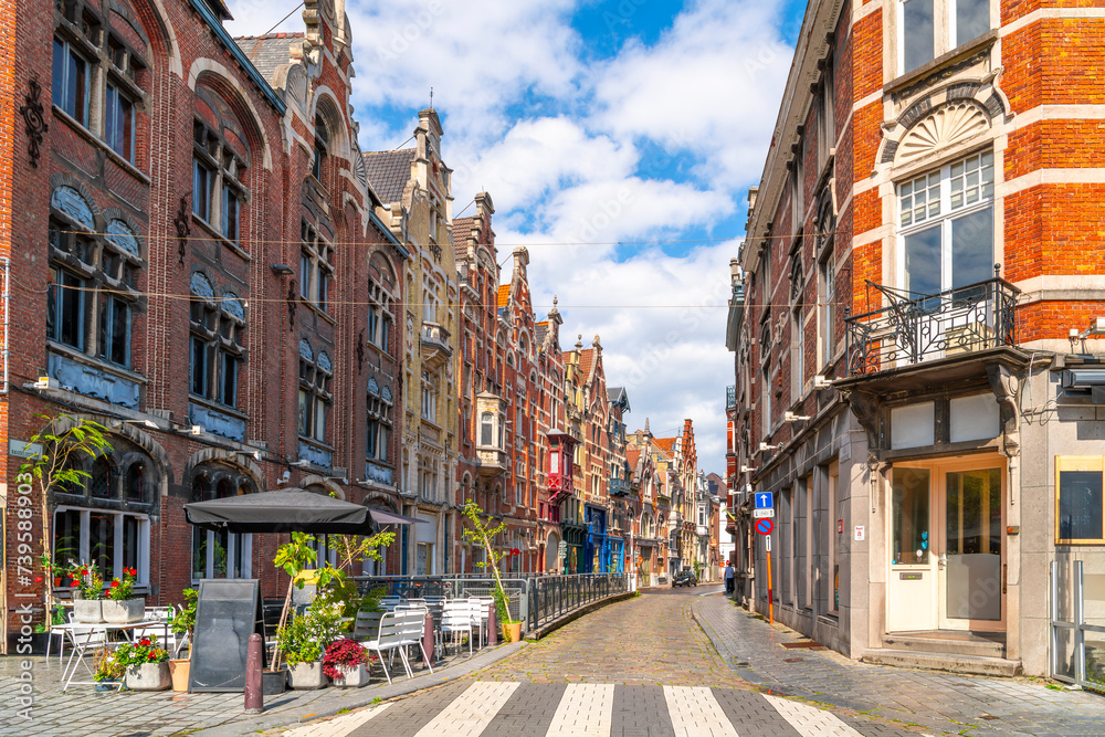 A row of eclectic style civic houses on Baudelostraat street seen from Vrijdagmarkt old town square in the historic center of Ghent, Belgium.