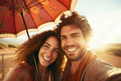 couple in desert having selfie with umbrella photo world premium image