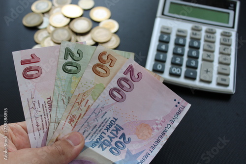 Fototapeta Naklejka Na Ścianę i Meble -  man counting Turkish money with his hand. Turkish lira banknotes. The paper currency of Turkey. For tax and hike news.