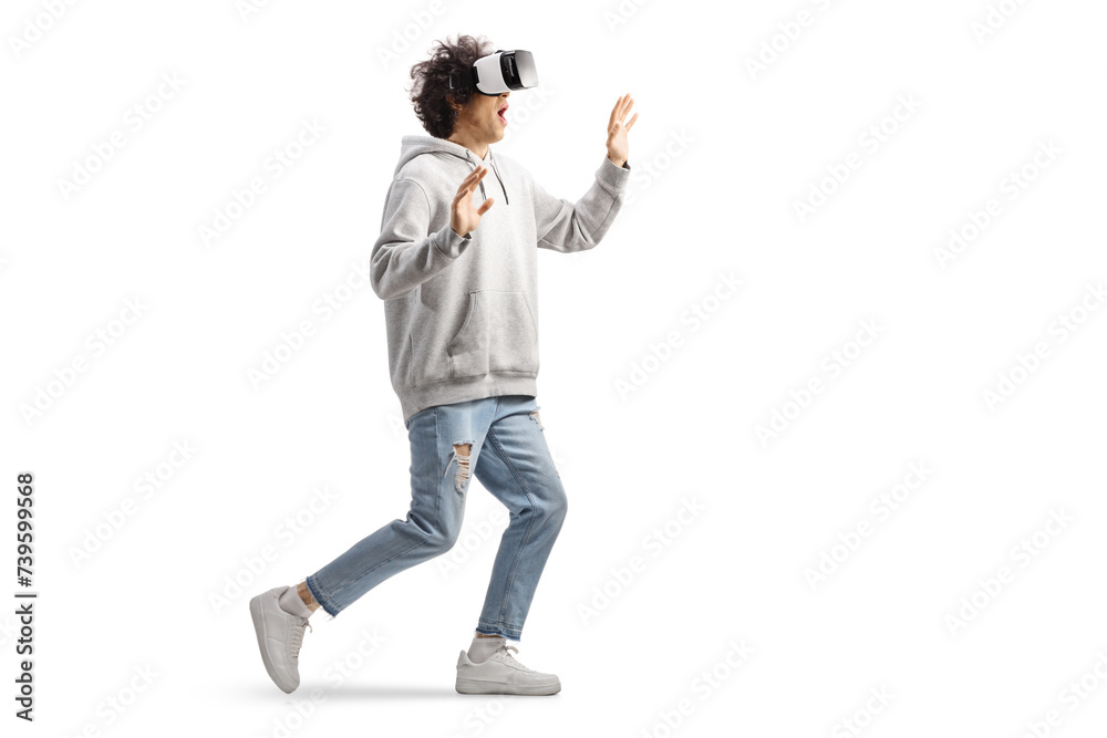 Young casual man with a VR headset walking and touching with hands Young casual man with a VR headset walking and touching with hands