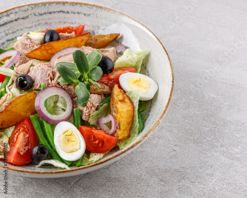 salad with tuna, quail egg and olives studio food photo 3