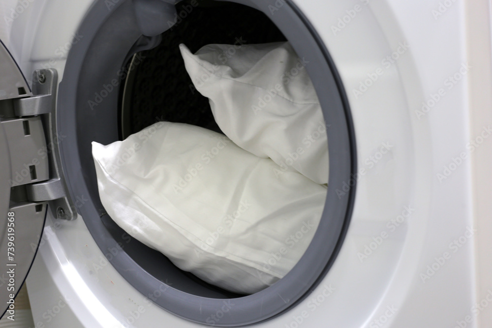White pillow in washing machine. White pillow in washing machine.