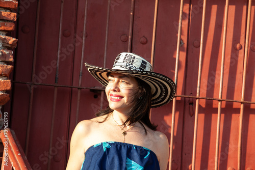 Beautiful woman wearing the traditional Colombian hat called Sombrero Vueltiao at San Ignacio Bulwark in the historical Cartagena de Indias walled city photo