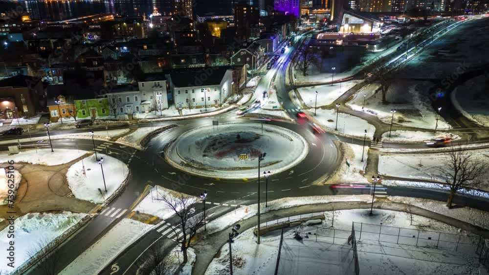 Aerial view Hyperlapse time lapse of traffic over the Beltway in downtown Halifax at night. The drone flies in a circle. Concept of public transport or suburban city life in Canada