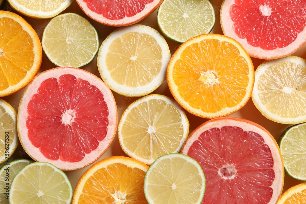 Different cut citrus fruits on beige table, flat lay Different cut citrus fruits on beige table, flat lay