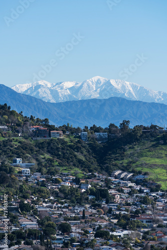 Los Angeles California Mt Washington hillside neighborhood with snow capped Mt Baldy peak in the background. 