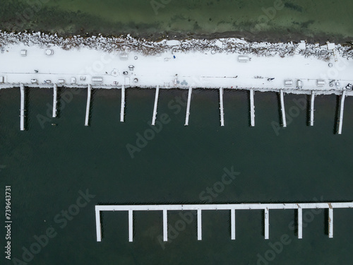 Winter afternoon aerial images of docks in Lansing, NY, on the east side of Cayuga Lake. photo