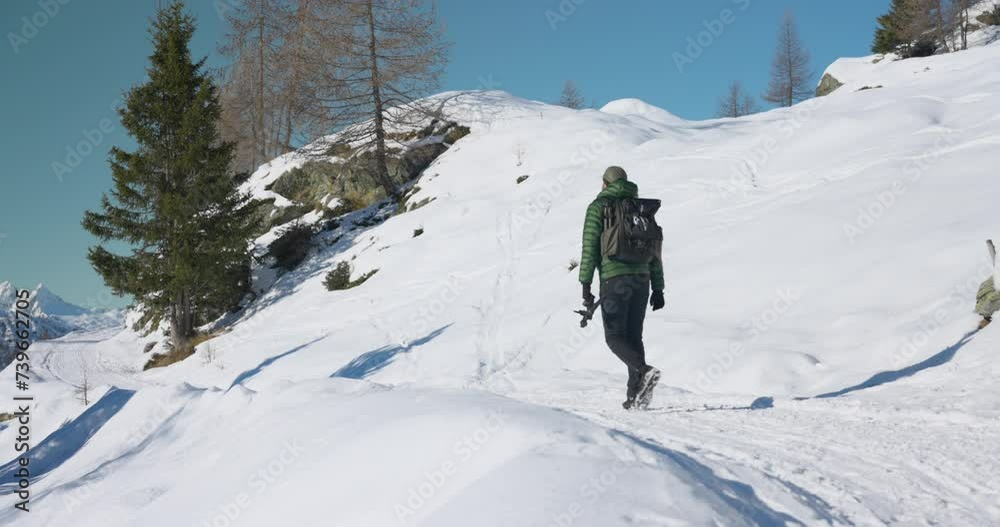 Campagneda Valmalenco snowy white trail with hiker passing by, clear sky Campagneda Valmalenco snowy white trail with hiker passing by, clear sky