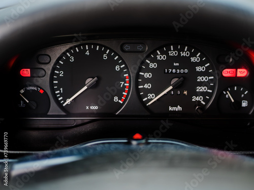 Close-up View of a Car Dashboard with Illuminated Gauges