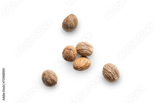Closeup organic whole raw nutmegs isolated on a transparent background with shadow from above, top view photo
