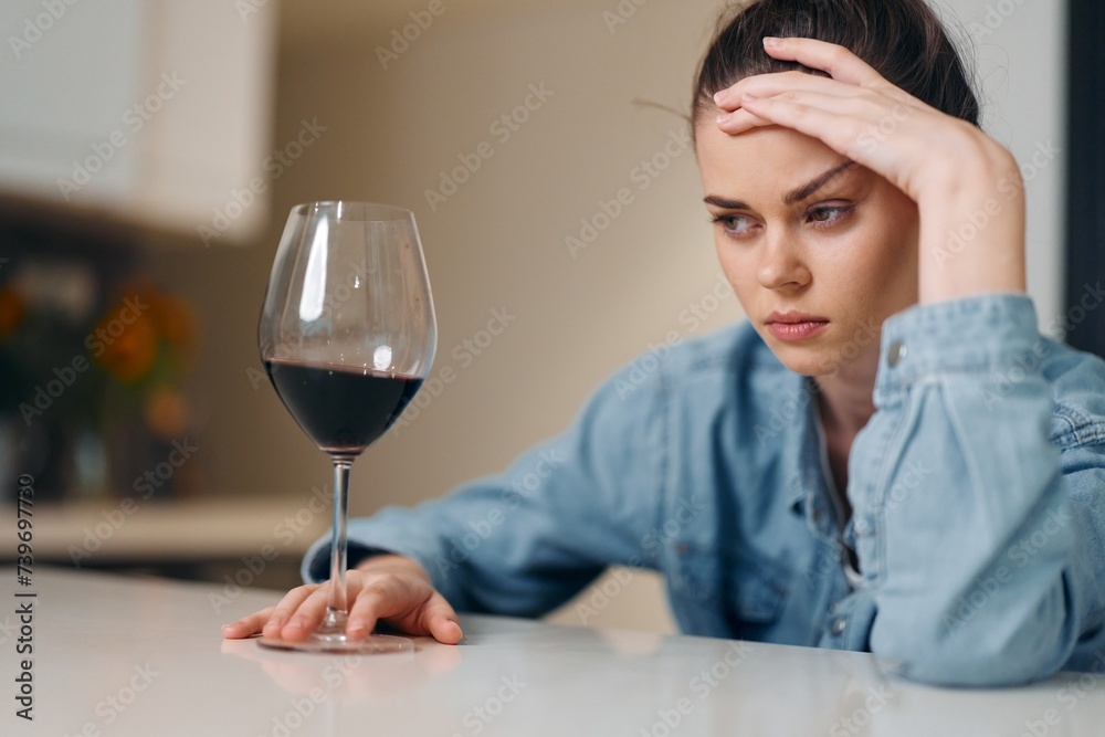 Depressed Woman Drinking Wine Alone: A Portrait of Sadness and Loneliness. Depressed Woman Drinking Wine Alone: A Portrait of Sadness and Loneliness.