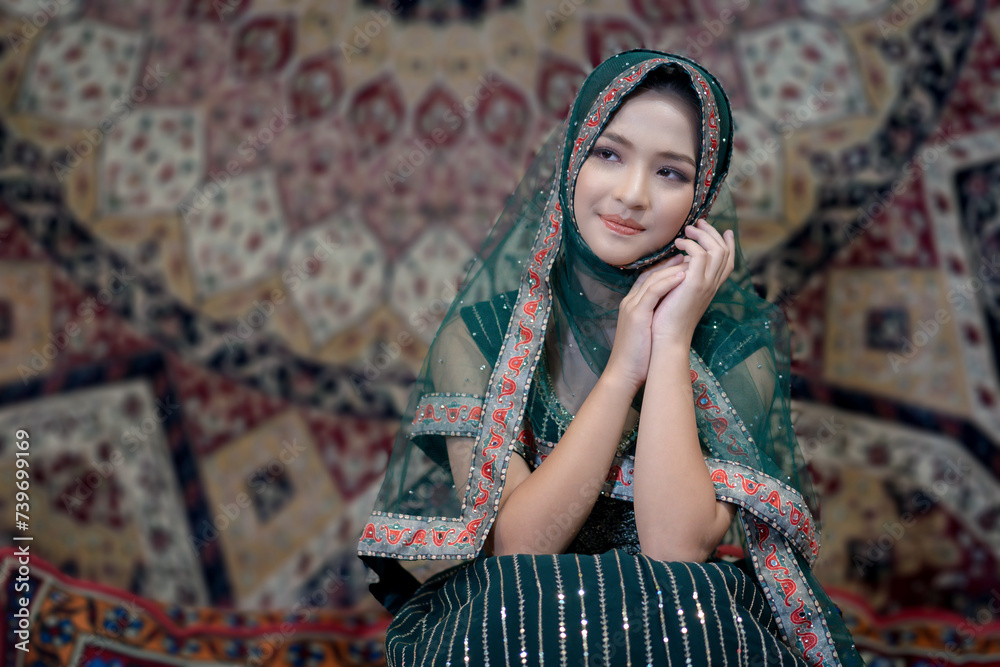 Fototapeta premium Beautiful Arabic Muslim woman the Arabian beauty wearing green Hijab clothes. Pretty Muslim girl. Portrait fashionable of Islamic female.